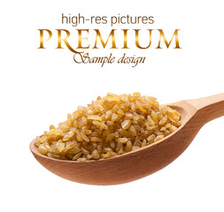 Bulgur in a wooden spoon  isolated on white background