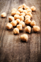 Golden  Chickpeas over rustic wooden table close up.  Traditiona