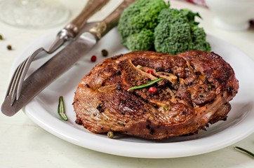 Roasted turkey steak with spice and broccoli on wooden background