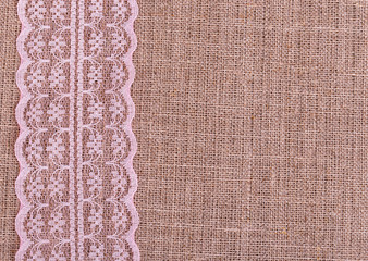 Background of burlap with pink lace
