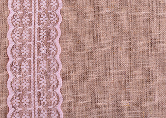 Background of burlap with pink lace