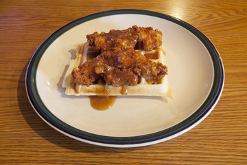Chicken and waffle covered with a maple bourbon sauce