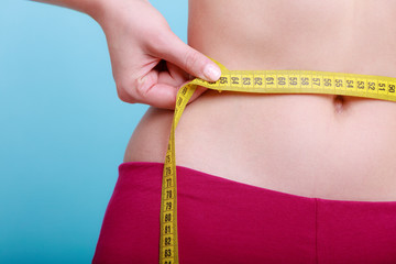Diet. Fitness woman fit girl measuring her waist