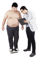 Doctor checking the weight of patient