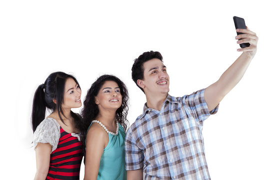 Multiethnic teenagers taking self photo