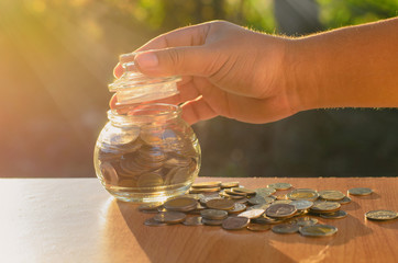 Male hand closing jar bank lid