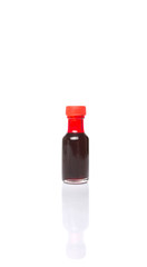 Liquid deep red food color additive over white background