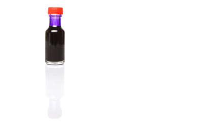 Liquid purple food color additive over white background