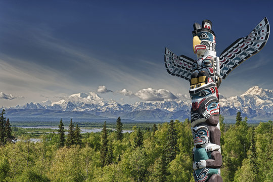 Mountain landscape with wooden totem pole 