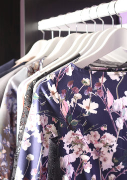 Female clothes collection on hangers in fashion store