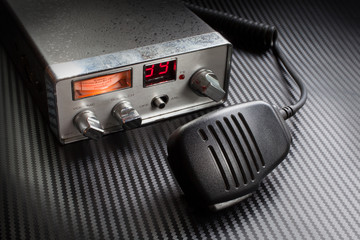 CB radio with microphone that is running on a carbon fiber surface