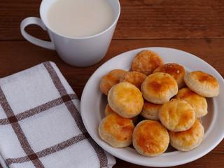 Homemade cheese cookies and cup of milk