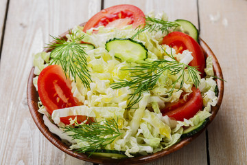 Cabbage salad with cucumbers and tomatoes