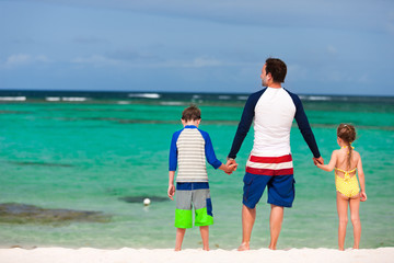 Father with kids at beach