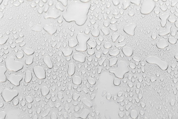 Metal surface covered in water drops.