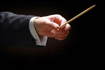 A concert conductor&#39;s hands with a baton, isolated on a