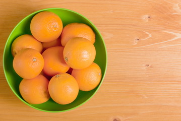 Beautiful ripe oranges on a yellow table