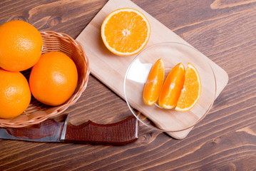 Obraz na płótnie Canvas sliced ripe appetizing delicious orange on cutting board next to