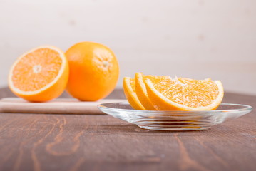 sliced ripe appetizing delicious orange on cutting board brown t