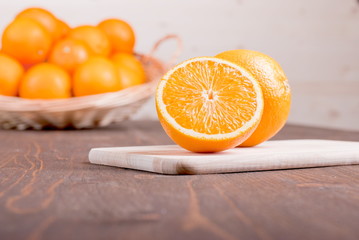 sliced ripe appetizing delicious orange on cutting board brown t