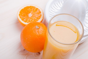 orange juice beside delicious ripe oranges on the table