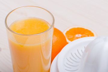 orange juice beside delicious ripe oranges on the table