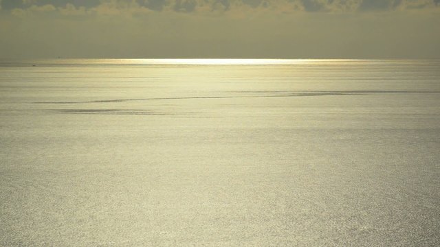 light beam shining through the cloudscape over the sea