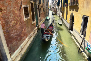 Fototapeta na wymiar Scenic canal with gondola, gondolier, Venice, Italy