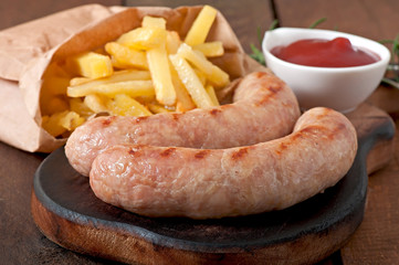 Chicken sausages grilled with a side dish of french fries