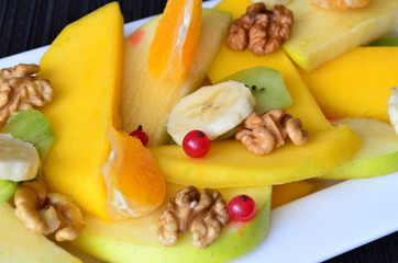 Salad of fruit with mango,walnuts,oranges,kiwi,bananas,apples