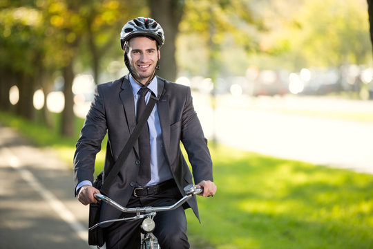 businessman riding a bicycle to work, concept  gas savings conce