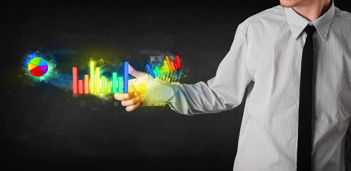 Handsome young business man touching colorful modern graph syste