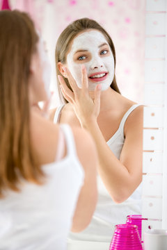 beauty girl getting facial mask
