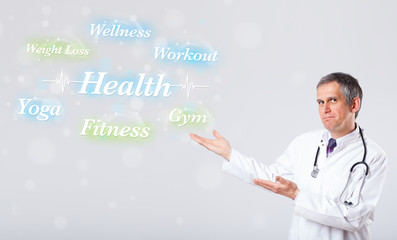 Clinical doctor pointing to health and fitness collection of wor