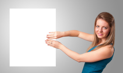 Young woman presenting white paper copy space