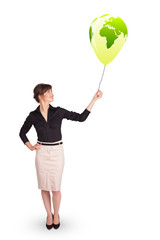 Happy lady holding a green globe balloon