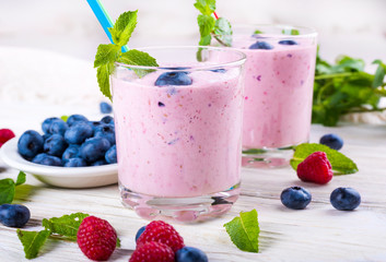 Milkshake with blueberries, raspberries and mint