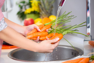 female hands washing carrots
