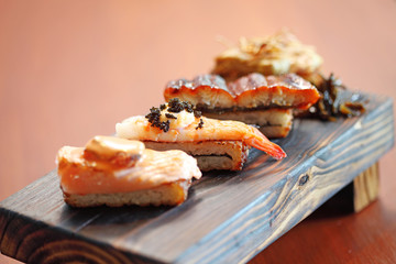 close up japanese food from fish and rice in wooden tray
