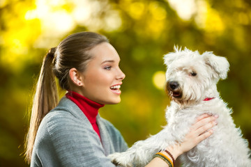Cheerful girl with her cute puppy