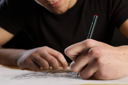 Artist Drawing A Tattoo