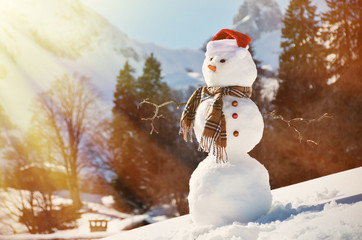 Snowman against Alpine panorama