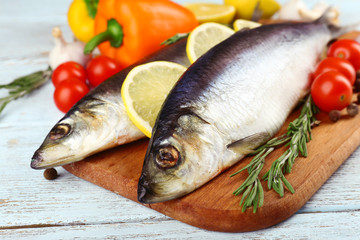 Fresh raw fish and food ingredients on table