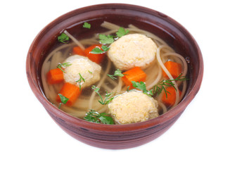 Soup with meatballs and noodles in bowl isolated on white