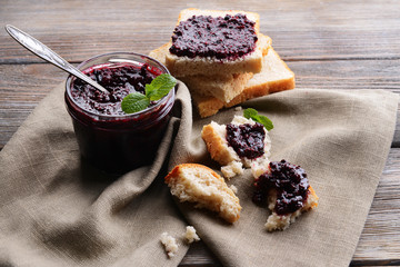 Delicious black currant jam on table close-up
