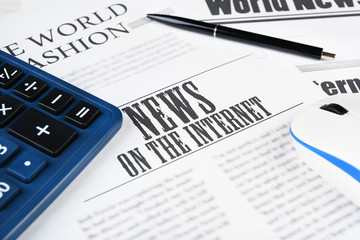 On-line news and business concept. Computer mouse, calculator