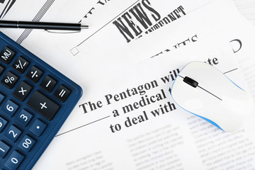On-line news and business concept. Computer mouse, calculator