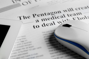 On-line news concept. Computer mouse, PC tablet and newspaper,