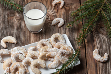 Vanille cookies and milk on a wooden table