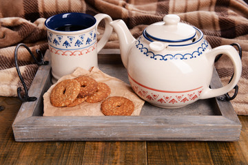 Cup of tea with cookies on table close-up